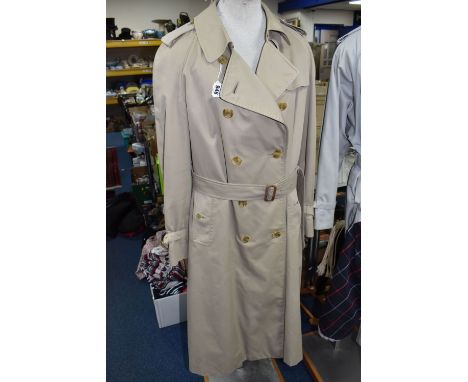 A LADIES BURBERRY'S TRENCHCOAT, AND A CHRISTIAN DIOR UMBRELLA, the coat in traditional Nova Check lining, belted, Archive Bei