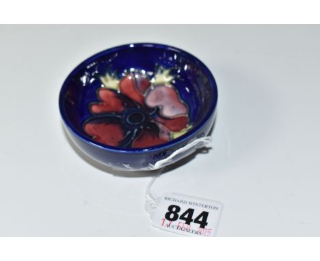 A MOORCROFT POTTERY 'ANEMONE' FOOTED BOWL, tube lined with a purple anemone on a blue ground, impressed and painted marks to 