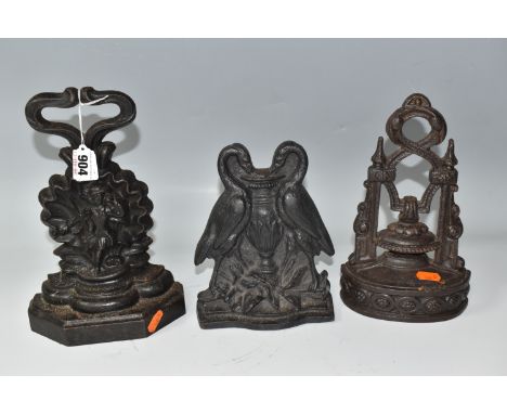 THREE VICTORIAN CAST IRON DOOR STOPS, comprising a door stop depicting a pair of swans impressed 45S on the back, height 19cm