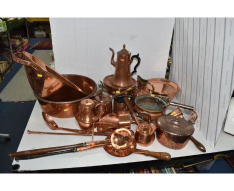 A LARGE QUANTITY OF COPPER ITEMS to include four oversized utensils, an ale muller, a milk jug with a repousse pattern, a ket