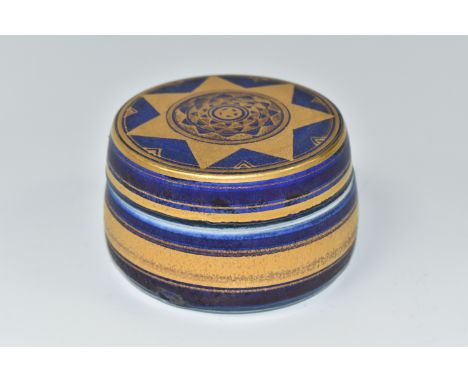 MARY RICH (1940-2022) A PORCELAIN COVERED TRINKET BOX, of tapering cylindrical form, decorated with gilt bands and a star mot