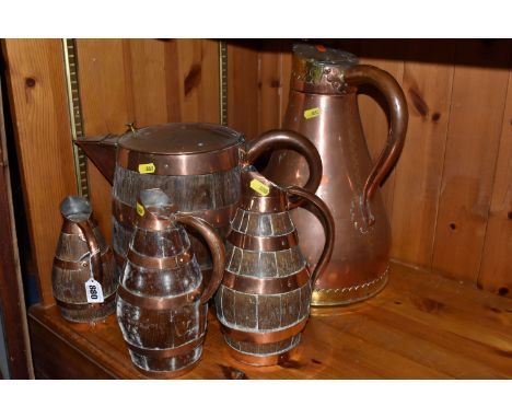 A COLLECTION OF GEORGIAN COOPERED KITCHEN STORAGE JUGS, with copper banding comprising a large copper pitcher with a hinged c