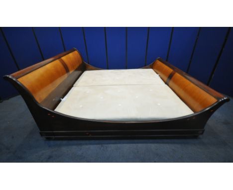 AND SO TO BED, A MODEL PALAIS WALNUT AND CHERRY VENEER LARGE EMPEROR SLEIGH BED, with dipped side rails, joining each scrolle