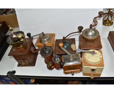 NINE VINTAGE COFFEE GRINDERS, comprising a tin and wood example by Peugeot, a wooden Peugeot example, with grinders by Pede D