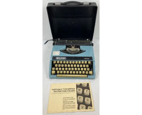 A vintage Wilding TW100 portable typewriter with hard carry case and instruction manual. 