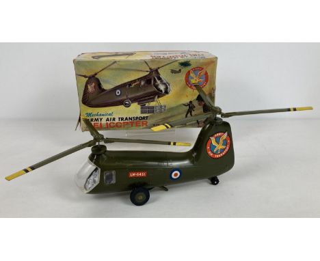 A boxed vintage mechanical Army Air Transport Helicopter with Revolving Blades by Louis Marx. Complete with original decals a