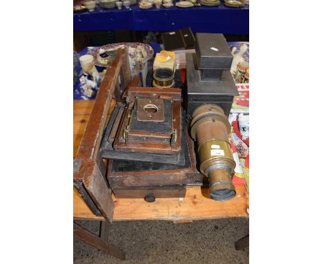 A large vintage brass mounted projector together with a range of accessories
