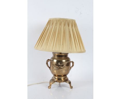 Japanese brass table lamp, having naturalistic branch carrying handles, the body centred with perched birds, raised on three 