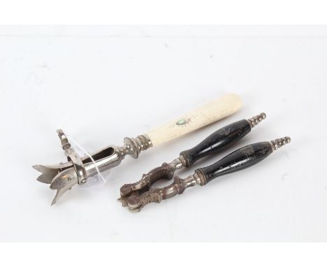 Bone handled and plated meat carving clamp, the handle with mother of pearl inlay, and a pair of ebonised and steel nutcracke