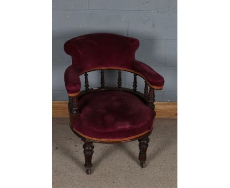 Late Victorian mahogany and upholstered tub chair, with spindled back rest and open arms, raised on ring turned legs and cast
