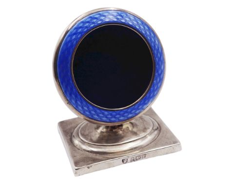 1920's silver pocket watch stand, of circular form with blue guilloche enamel detailed front, upon a spreading stem and recta