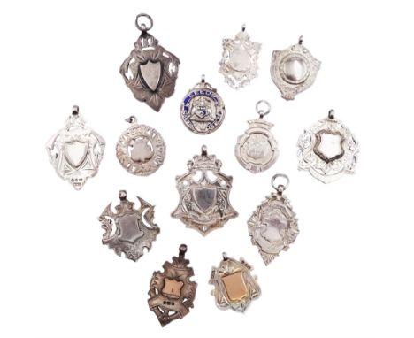 Thirteen silver fobs form, mostly Victorian and Edwardian examples, to include two gold facing examples, and seven double sid