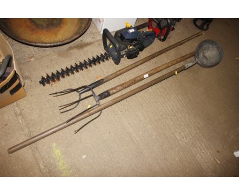 A hay fork and a muck fork and a long handled ladle 