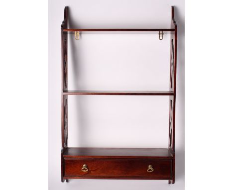 A Georgian design mahogany wall shelf, fitted shallow drawer, with fretted sides