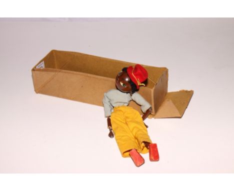 A Pelham puppet of a coloured girl wearing a blue top and yellow trousers (lacks control bar and strings)