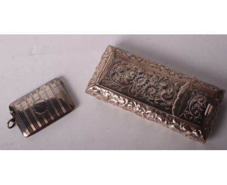 An embossed silver box, 3.5oz troy approx, and an engine turned silver vesta case, .96oz troy approx