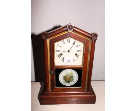 A late 19th Century American mantel clock with eight-day striking movement and floral decorated door