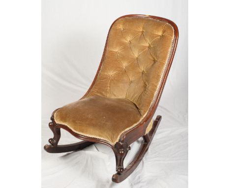 A Victorian mahogany showframe rocking chair, button upholstered in a green fabric