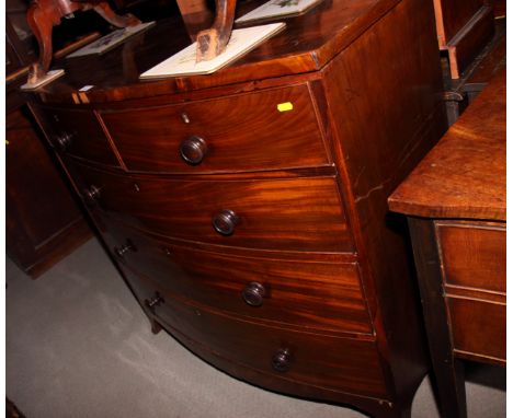 A George III mahogany bowfront chest of two short and three long drawers with turned wood knobs, on cut away bracket supports