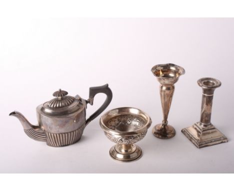 A silver half fluted teapot with composition handle, 7.4oz gross, a filled silver candlestick, a silver flower vase with weig