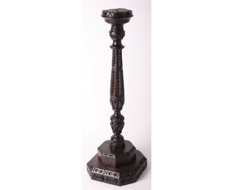 A 17th Century and later carved wood candlestick on stepped square base, 26" high