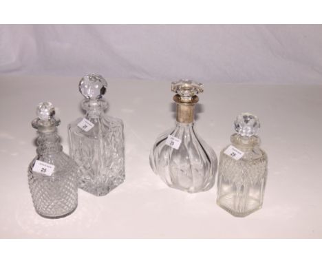 A Georgian cut glass three ring necked decanter, a silver mounted decanter and two spirit decanters