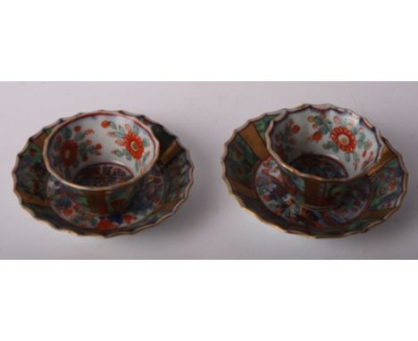 A pair of Japanese floral decorated and later gilt miniature tea bowls and saucers