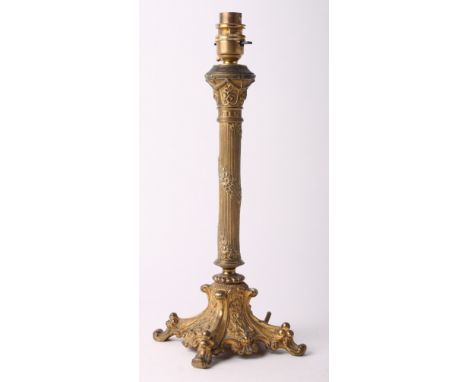 A brass table lamp formed as a reeded column on scroll base