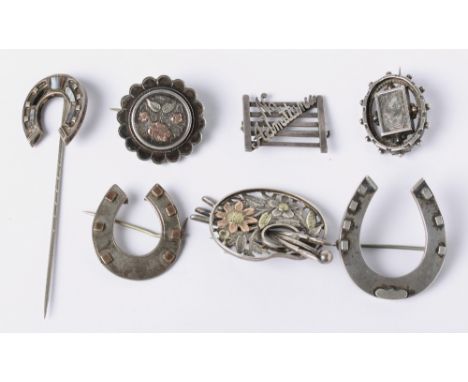 Six Victorian and later silver brooches (three gold mounted) and a hardstone mounted silver horseshoe stick pin