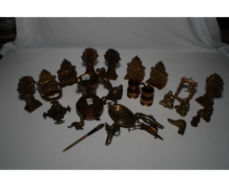 A brass pestle and mortar, two brass measures, a pair of seated brass Buddhas, a set of four brass Taj Mahal bookends, four "