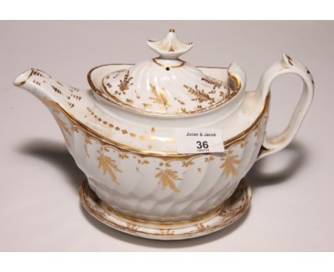 A 19th Century bone china gilt decorated teapot on stand