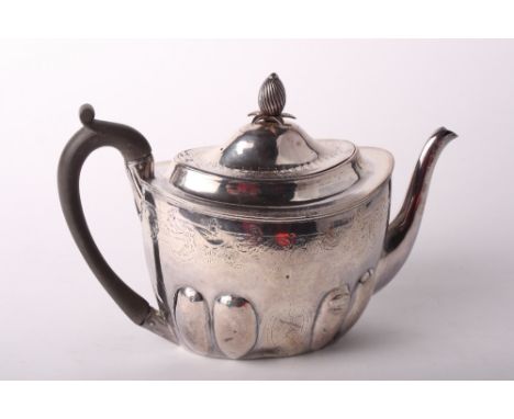 A Georgian silver lobed oval teapot, spiral fluted pineapple finial and composition handle, 13.7oz gross