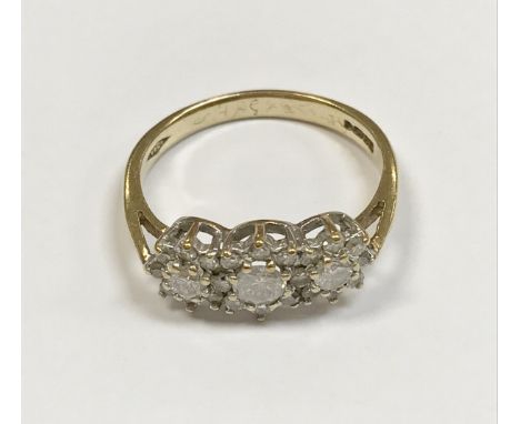 A 9 carat gold and diamond set dress ring, the three central stones approx 0.1 carat, within a flower head design of further 