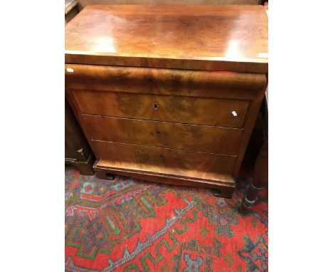 A 19th Century Continental walnut commode of four graduating drawers on bracket feet