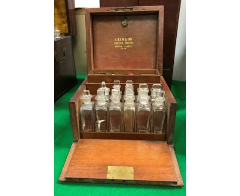 A Victorian mahogany apothecary's cabinet, the top opening to reveal a fitted interior with fourteen bottle compartments and 