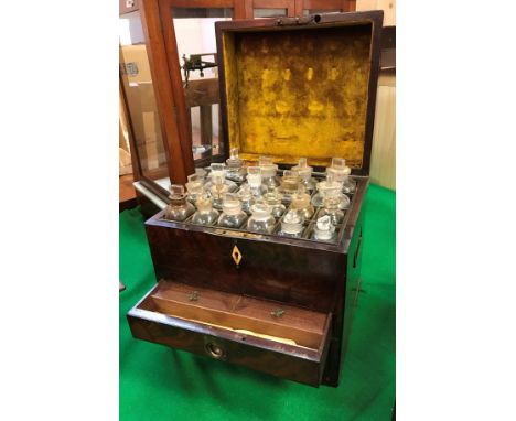 A 19th Century figured mahogany and ebony strung apothecary's chest, the lid opening to reveal twenty bottles over a drawer f
