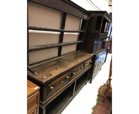 An 18th Century oak dresser the two tier plate rack (cut down) over three frieze drawers raised on square supports united by 