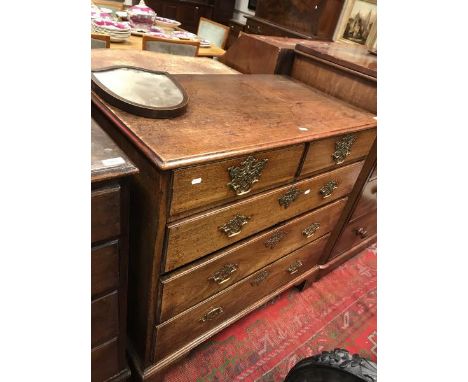An oak chest of two short over three long graduating drawers to bracket feet 