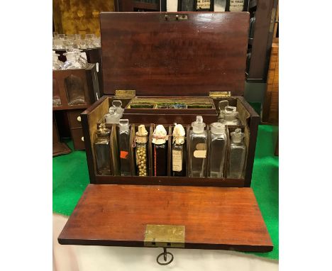 A 19th Century mahogany apothecary's chest, the top and folding front opening to reveal a fitted interior with twelve various