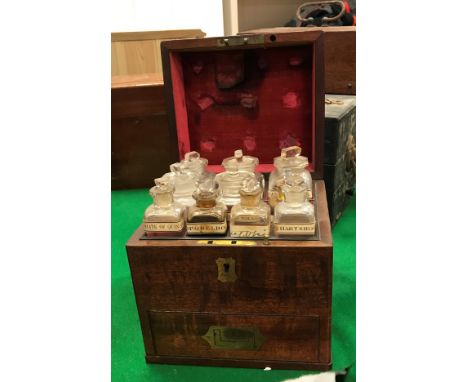 A 19th Century mahogany apothecary's chest, the top opening to reveal ten bottles over a fitted drawer containing pestle and 