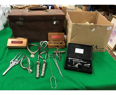 A leather-covered case containing various medical equipment/tools, including Down Bros of London forceps, silkworm gut steril