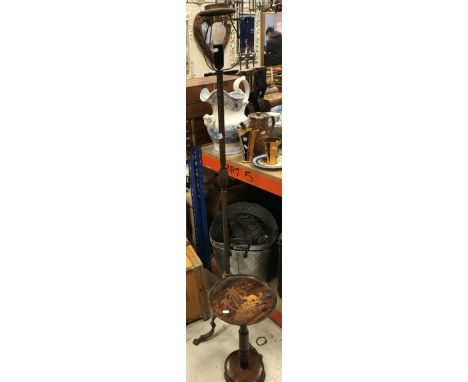 An embossed brass standard lamp on tripod base together with an Indian rosewood and marquetry inlaid wine table, the top deco