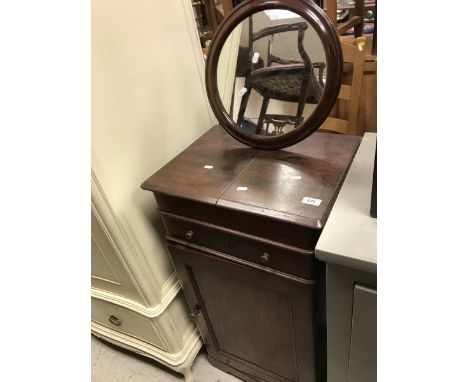 A Victorian mahogany gentleman's shaving stand with circular mirror over a two part rising top and drawer, over a cupboard do