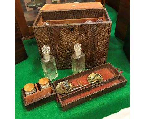 A Victorian embossed leather covered apothecary's cabinet fitted with two lift out compartments, one with scales the smaller 