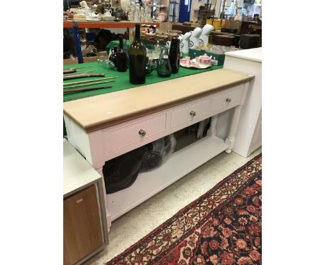 A Painted Furniture Company console table the oak top above three short drawers united by a pot shelf 