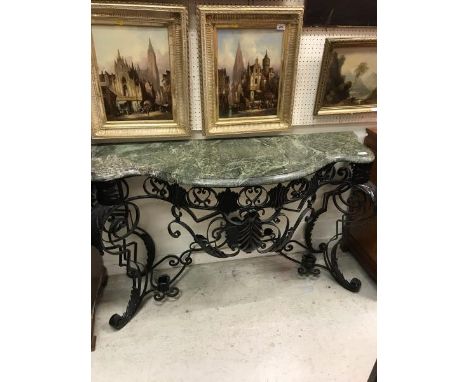 A wrought iron console table in the Rococo style black painted with green marble top CONDITION REPORTS Approx 48cm depth x 15