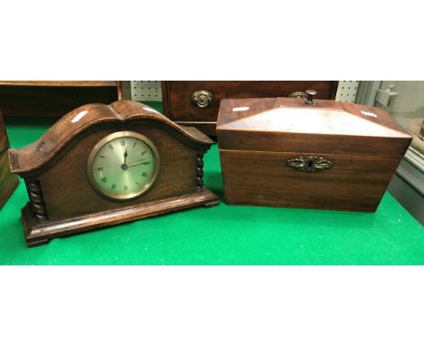 A 19th Century mahogany and satinwood strung tea caddy of sarcophagus form and an early 20th Century oak cased mantle clock 