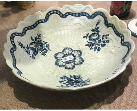 An 18th Century Worcester shaped circular junket dish moulded in relief with foliage and basket work decorated under glazed b