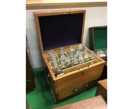 An early 20th Century ash-cased apothecary's chest, the rising top opening to reveal a fitted interior with seventeen various