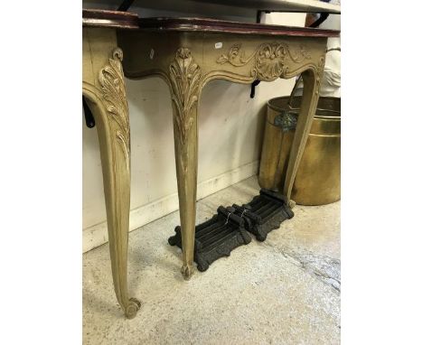 A pair of console tables the painted tops above carved scrolling shelf decoration raised on two legs to scrolling feet 